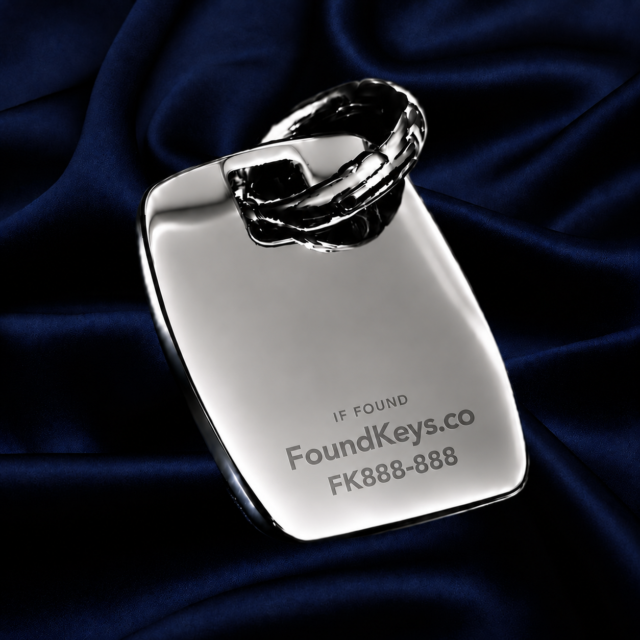 Reverse of a FoundKeys keyring engraved with IF FOUND, FoundKeys.co and a unique retrieval code